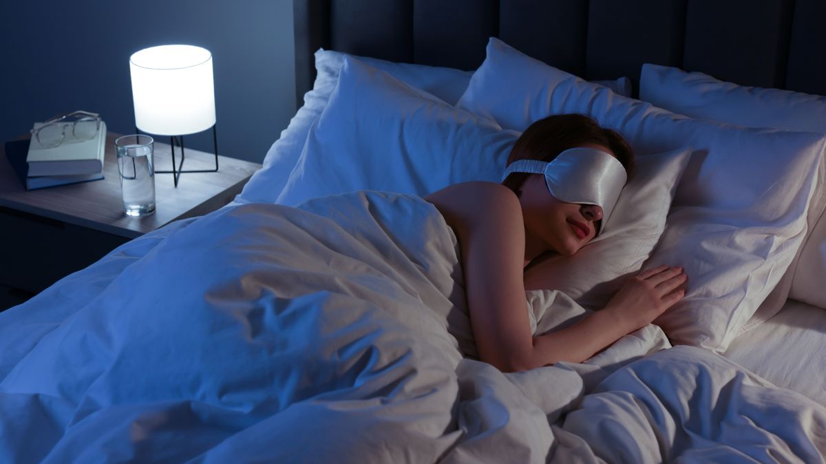 Woman,With,Mask,Sleeping,In,Bed,At,Night