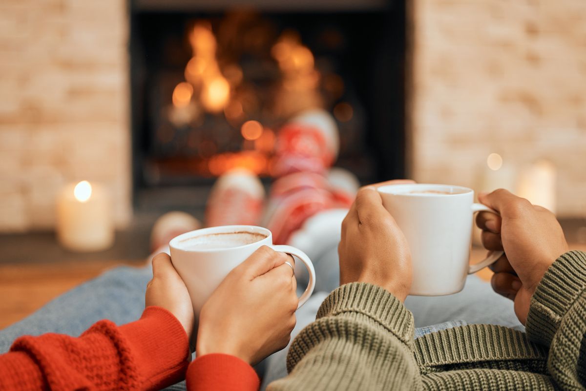 Hands,,Coffee,And,Couple,Relax,By,Fireplace,,Bonding,And,Cozy