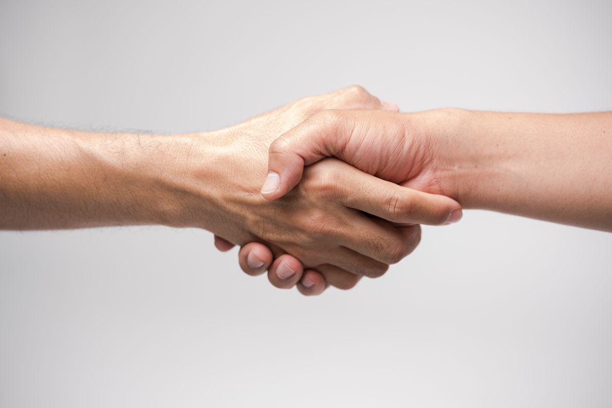 Close,Up,Two,Man,Shaking,Hand,On,White,Background.athletes,Shaking