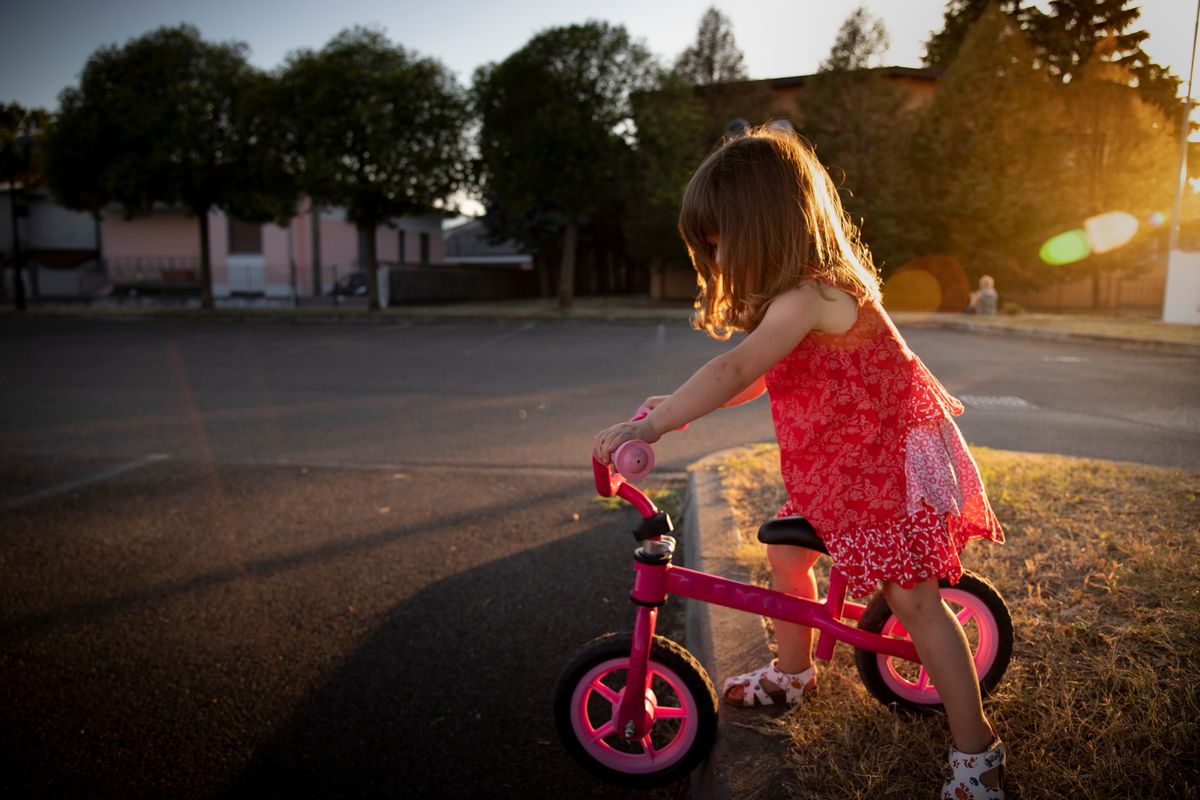 Toddler,Child,Girl,Riding,Her,Dynamic,Bycicle,In,Urban,Outdoor