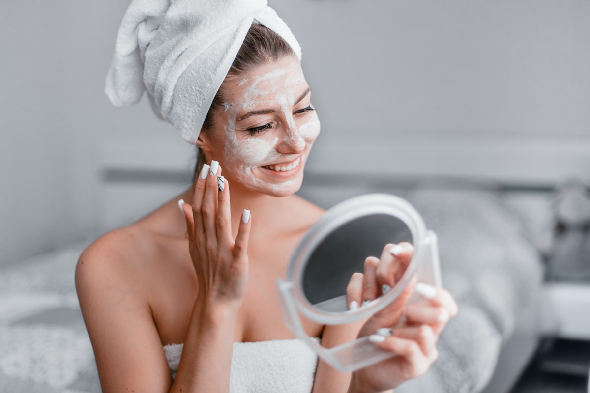 Woman,In,Her,Room,Making,Facial,Mask,Holding,Mirror,In
