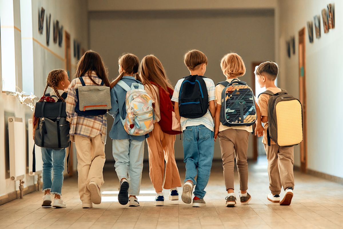 Back,To,School.,A,Group,Of,Schoolchildren,With,Backpacks,Walk