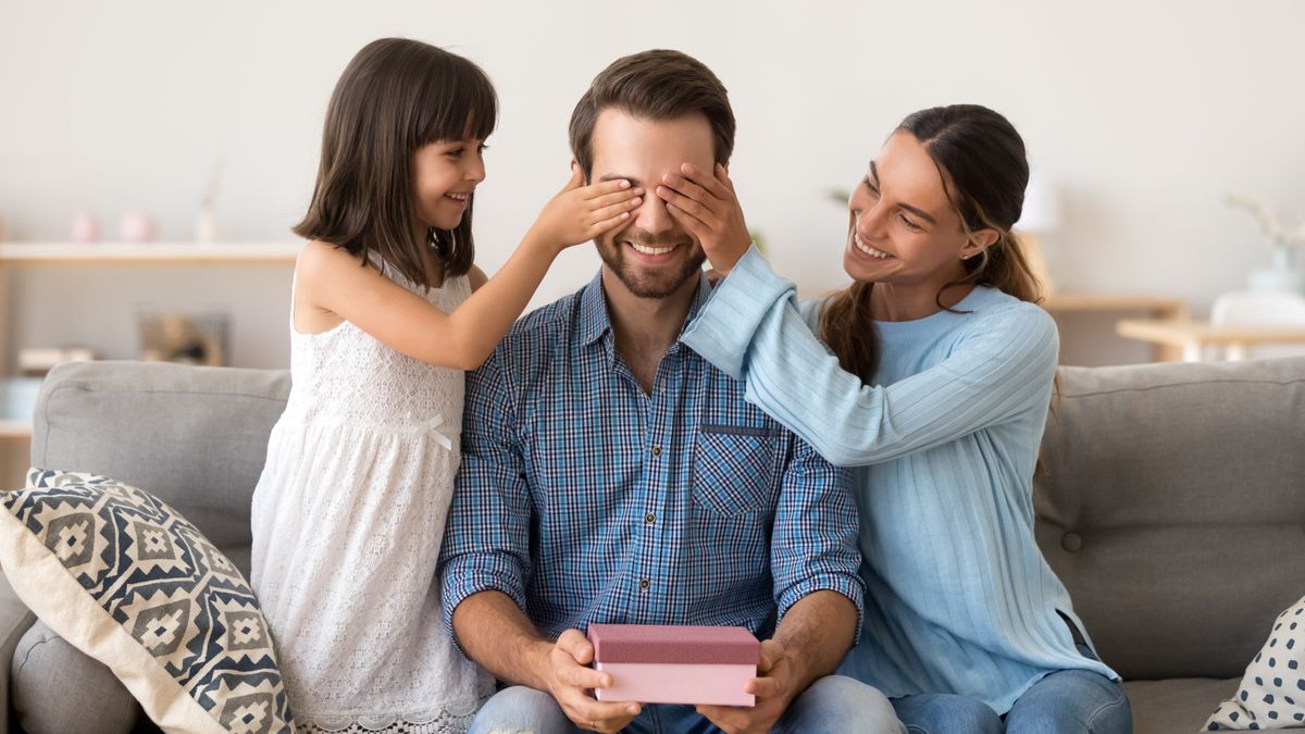 Loving,Wife,And,Kid,Daughter,Making,Surprise,To,Smiling,Dad