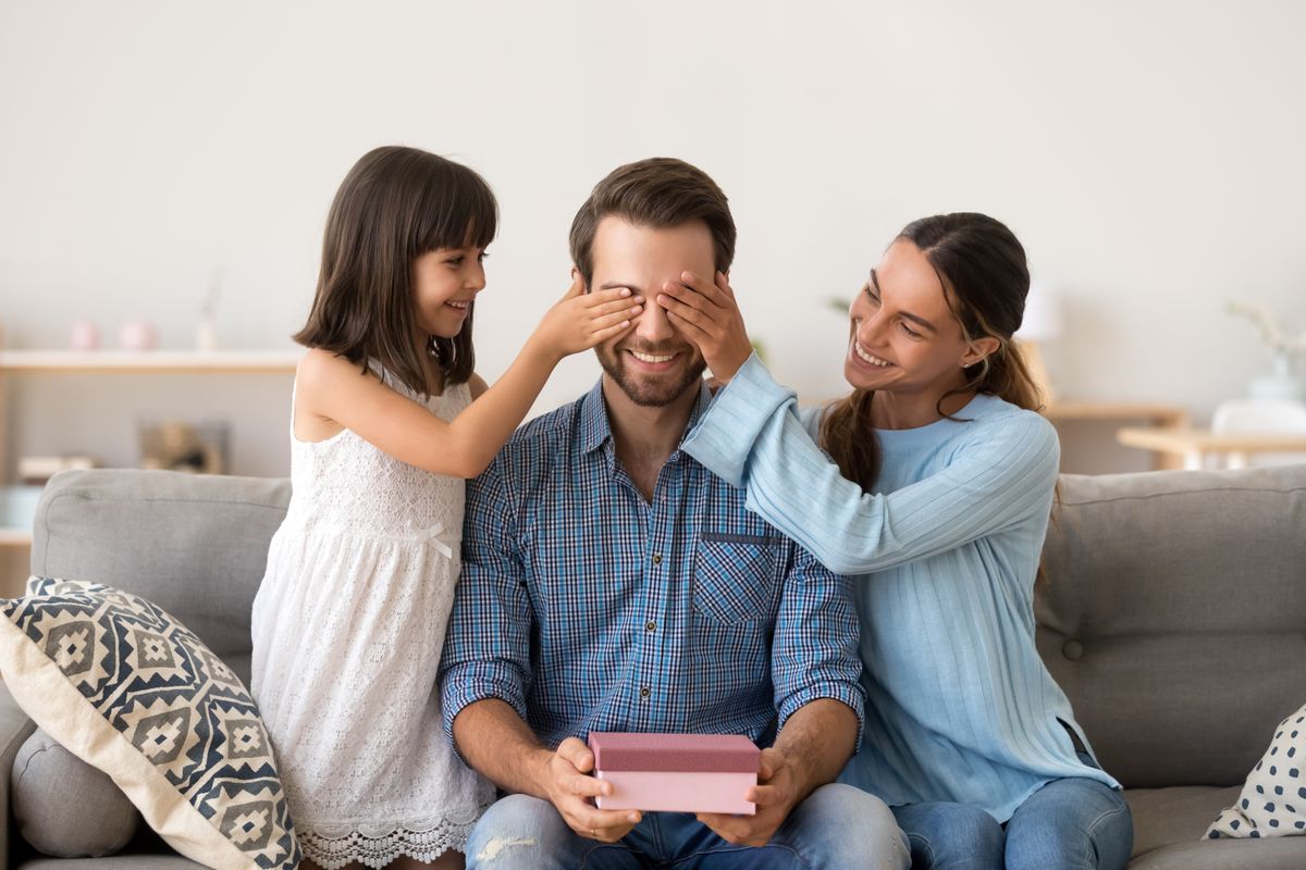 Loving,Wife,And,Kid,Daughter,Making,Surprise,To,Smiling,Dad