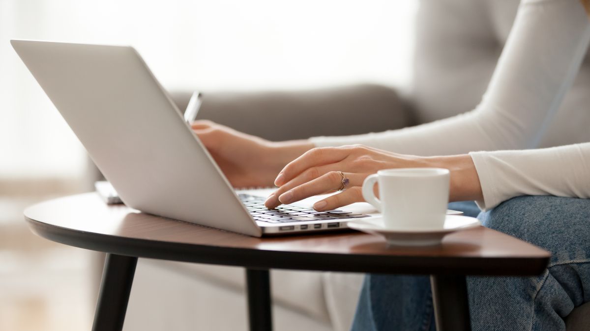 Close,Up,Woman,Using,Laptop,,Sitting,On,Sofa,,Female,Hands