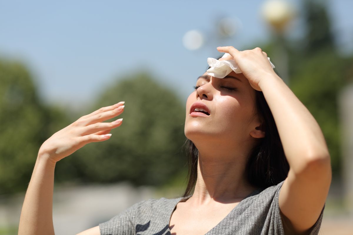 Stressed,Asian,Woman,Drying,Sweat,With,A,Cloth,In,A