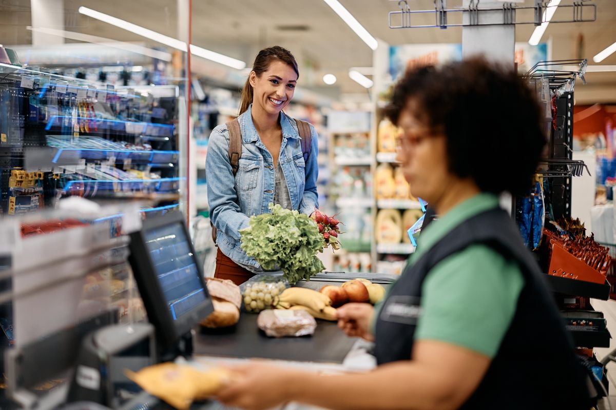 Young,Happy,Woman,Paying,For,Groceries,At,Checkout,In,Supermarket.