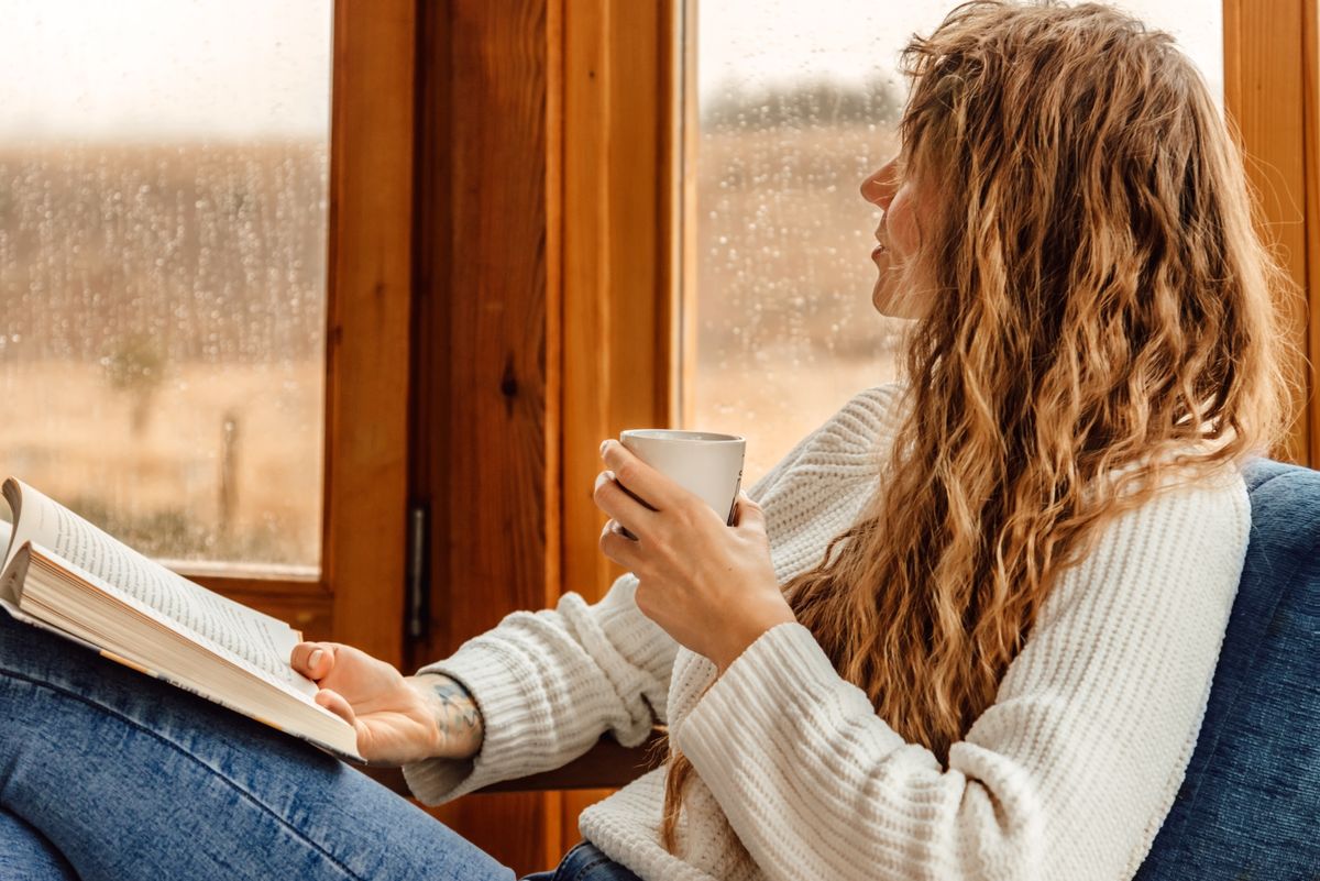 Young,Woman,Reading,Book,And,Drinking,Coffee,Or,Cocoa,At