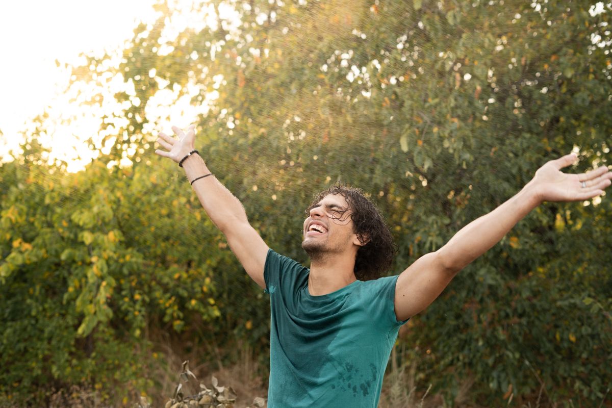 Happy,Young,Arab,Man,Enjoying,Freedom,Under,Raindrops,Enjoying,The