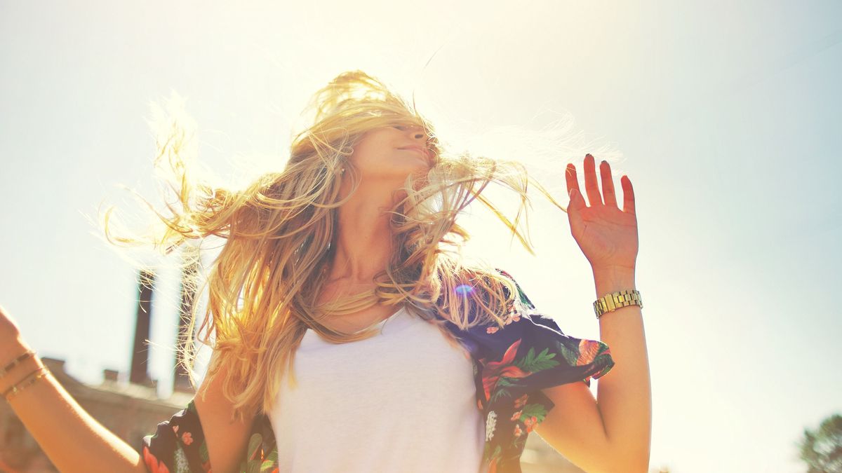 Attractive,Happy,Young,Woman,In,White,T,Shirt,Flying,Hair