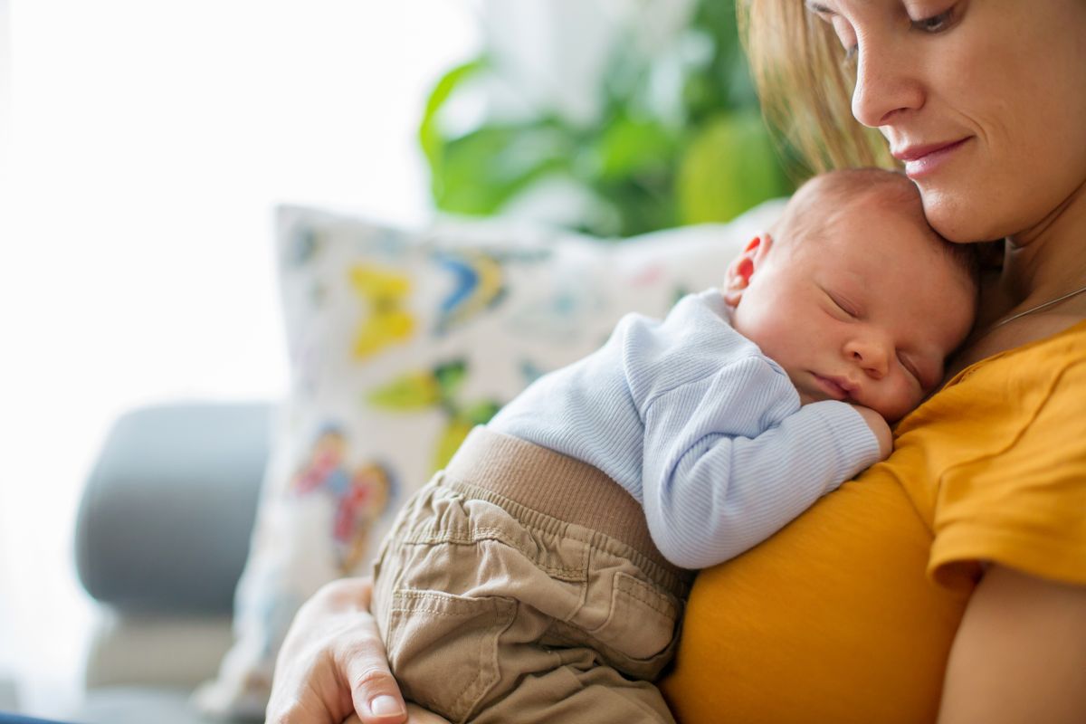 Young,Mother,,Holding,Tenderly,Her,Newborn,Baby,Boy,,Close,Portrait