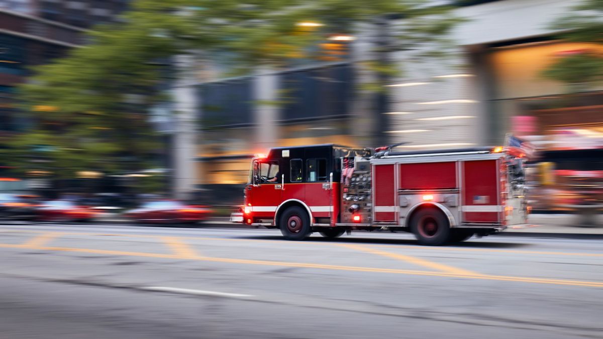 Fast,Moving,Fire,Engine,On,City,Street.,Firefighters,In,Blurred